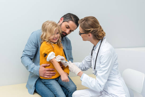 istock doctor doing vaccination for little girl 900821464