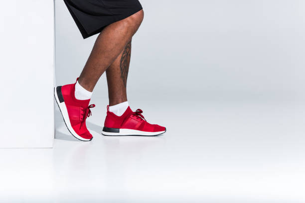 istock sportsman in red sneakers on grey 900824420