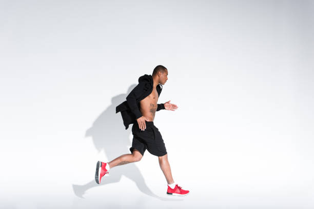 istock man in sportswear running on grey 900824476
