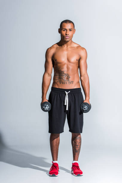 istock sportsman holding dumbbells 900824796
