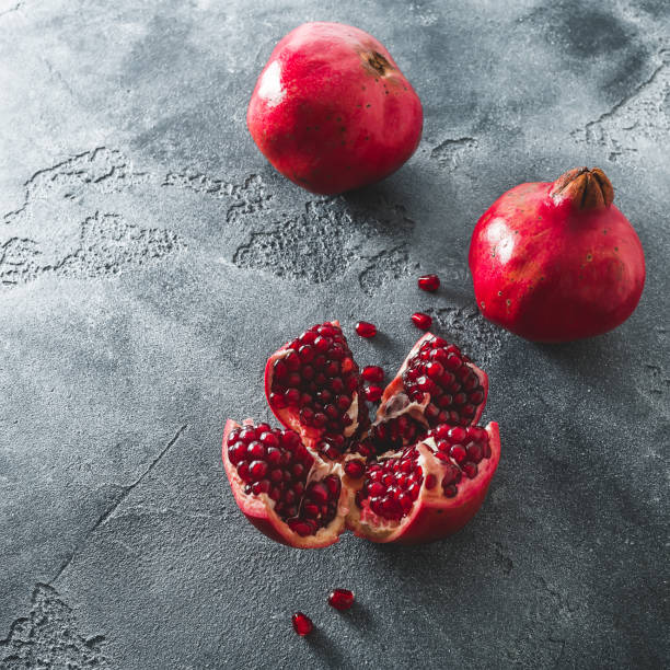 istock Pomegranate on dark background. Flat lay, top view. Fruit still life 900827612