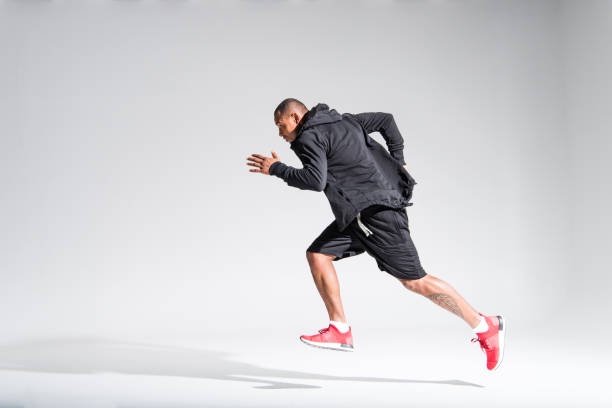 istock sportsman running on grey 900827960