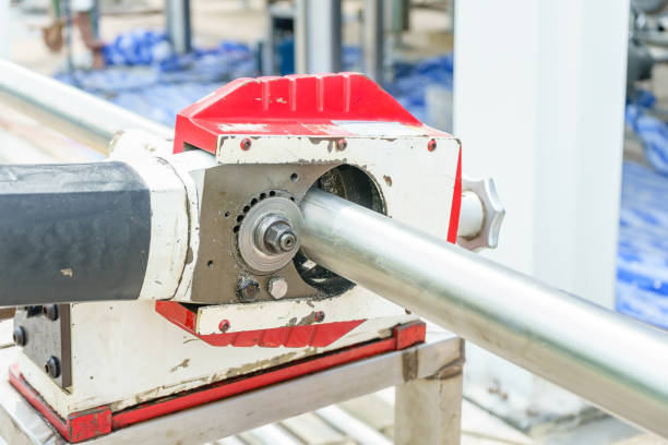 istock Construction Worker sawing a pipe by portable orbital pipe cold cutting machine 900828744