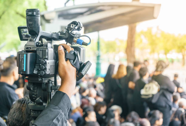 istock Photographer video recording activity within the event 900829064