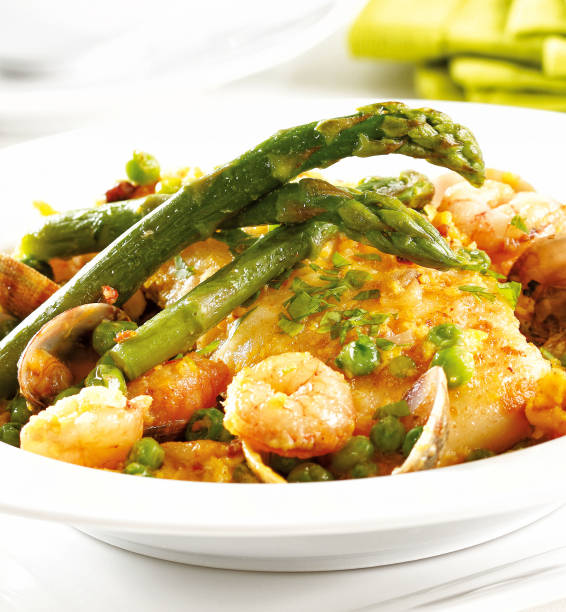 Seafood dish Seafood dish with green asparagus, clams and prawns. food state preparation shrimp prepared shrimp stock pictures, royalty-free photos & images