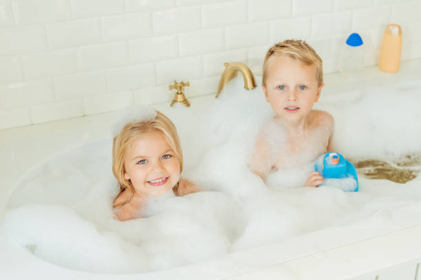 istock kids playing in bathtub with foam 900829804