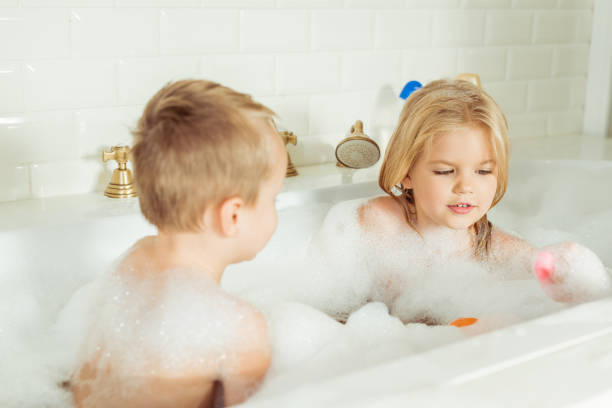 istock kids playing in bathtub with foam 900832040