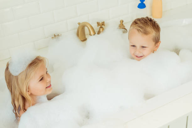 istock kids playing in bathtub with foam 900832156