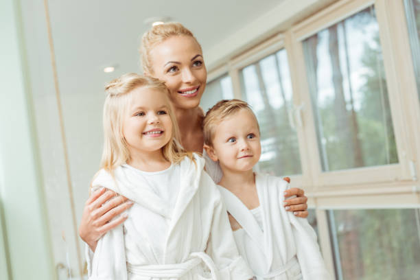 istock mother and children in bathrobes 900832888