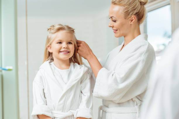 istock mother and daughter in bathrobes 900833828