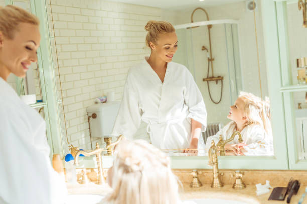 istock mother and daughter in bathrobes 900833938