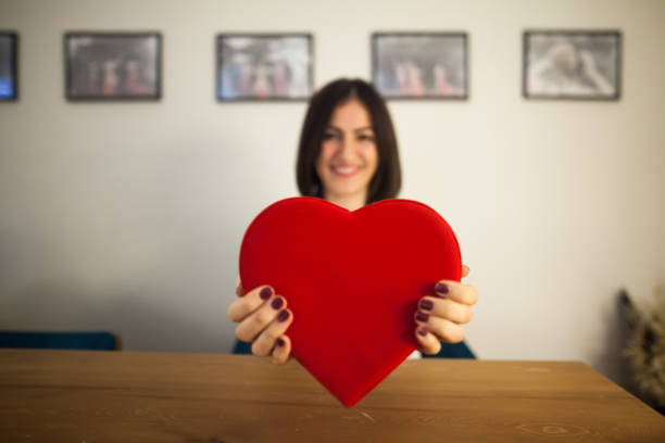 istock Woman holding heart shaped gift box on Valentine's Day 900834062