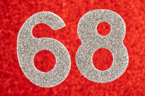 istock Number sixty-eight silver color over a red background. Anniversary 900834086