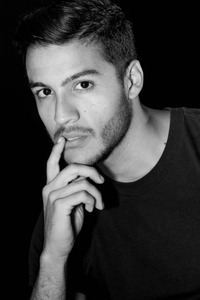 istock Man Portrait Looking Camera Serious Hand on Face 900836558