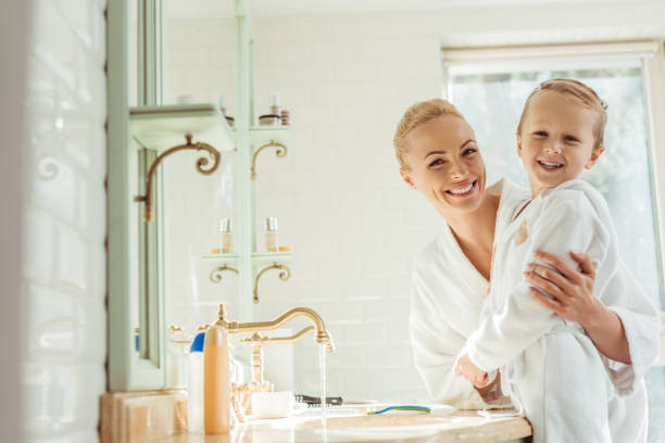 istock mother and son in bathroom 900837060