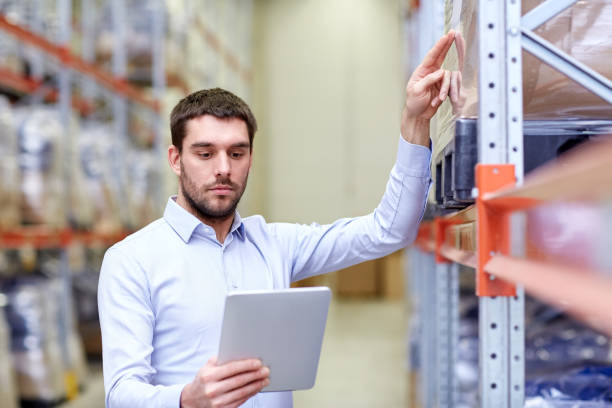 istock businessman with tablet pc at warehouse 900837338