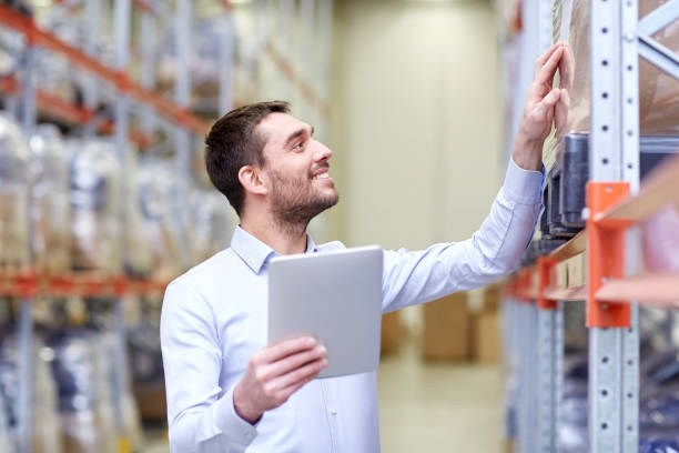 istock happy businessman with tablet pc at warehouse 900837616