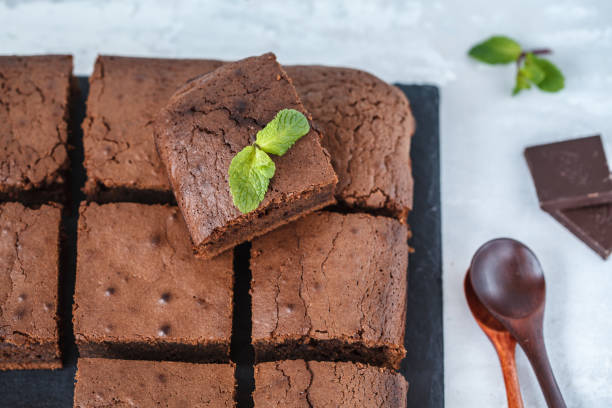 istock Square pieces of dark chocolate brownie on a slate board 900837634