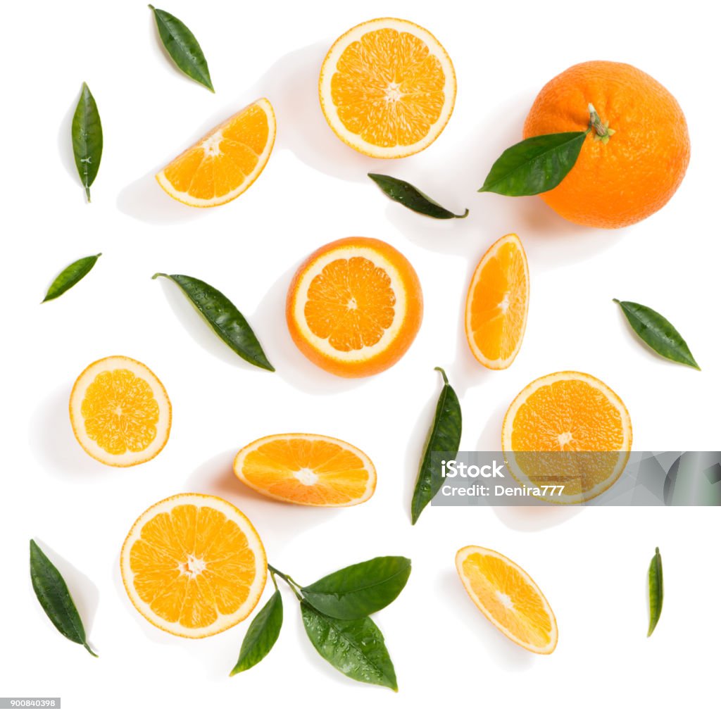 Oranges with leaves. Above view. Background made of orange fruits and green leaves isolated on a white background. Top view. Orange - Fruit Stock Photo