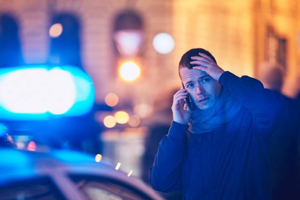 Young man calling after a crisis situation Young man calling after a crisis situation on city street. Themes crime, emergency medical service, fear or help. witness stock pictures, royalty-free photos & images