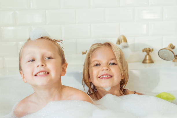 istock kids playing in bathtub with foam 900841088