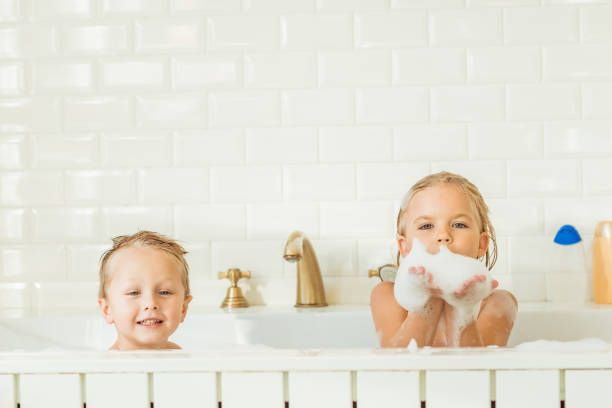 kids playing in bathtub with foam