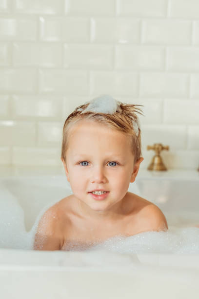 istock little boy in bathtub 900841678