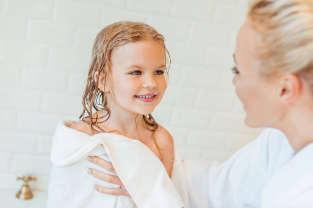 istock mother and daughter after bath 900842030
