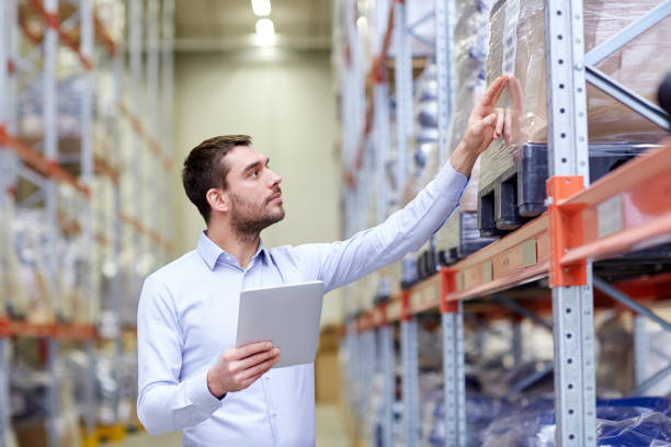 istock businessman with tablet pc at warehouse 900842062