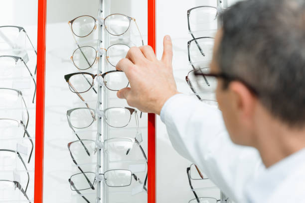 istock selective focus of optometrist taking eyeglasses from shelf in optics 900842138