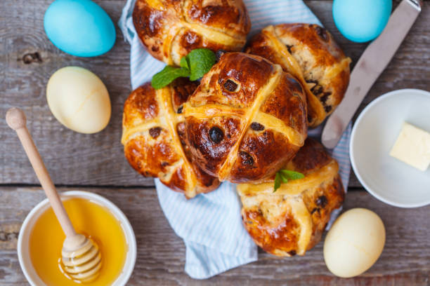 istock Easter cross buns, painted eggs. Wooden background, copy space, top view. Easter food concept. 900844320