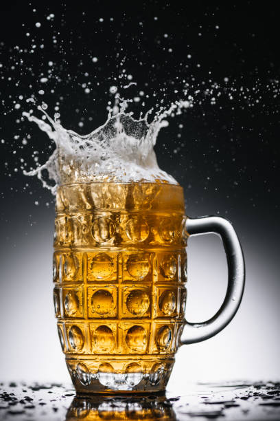 istock splashes of cold light alcohol beer in mug 900845108