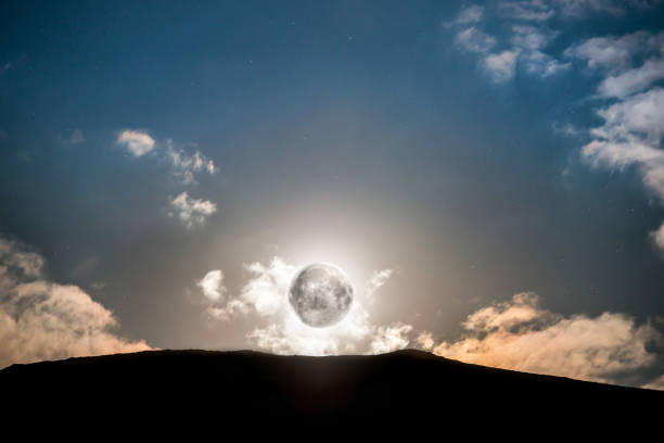istock Raising of full moon above mountain 900845364