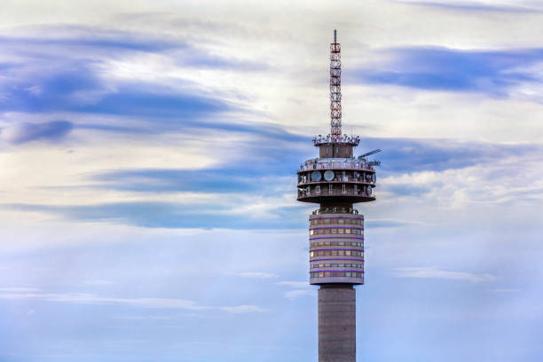 The top of the communication tower in Johannesburg city, seen close up, with a moody cloudscape at sunset.