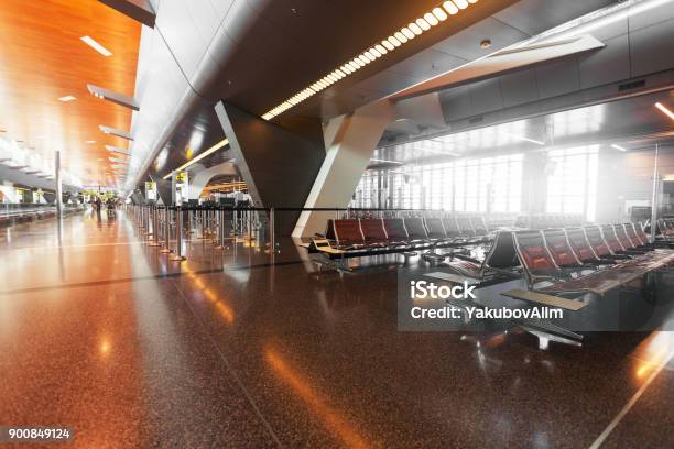 Modern Airport Terminal With Black Leather Seats At Sunset Stock Photo - Download Image Now
