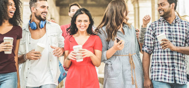 istock Happy millennials friends having fun together - Young students drinking coffee and laughing after university lessons - Youth lifestyle, school and friendship concept - Main focus on left man 900849840