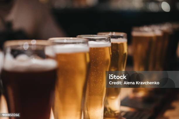 Close Up Of A Rack Of Different Kinds Of Beers Dark To Light On A Table Stock Photo - Download Image Now