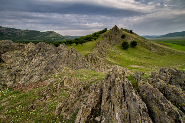 istock Beautiful spring lanscape with rocks, trees and clouds 900852690
