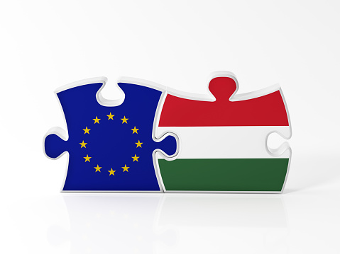 Jigsaw puzzle pieces textured with European Union and Hungarian flags on white. Horizontal composition with copy space. Clipping path is included.