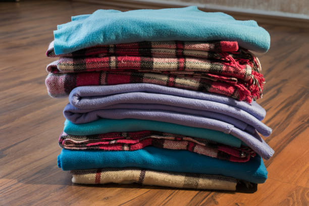 istock Pile of blankets on the wooden floor 900856246