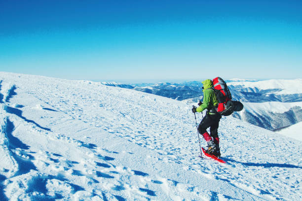istock Winter hike in the mountains with a backpack and tent. 900860916