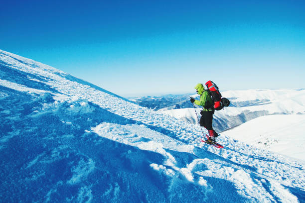 istock Winter hike in the mountains with a backpack and tent. 900860930