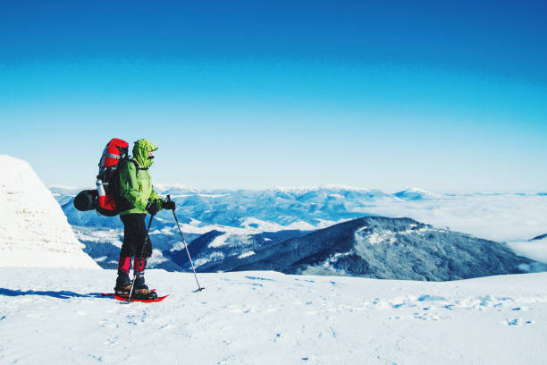istock Winter hike in the mountains with a backpack and tent. 900860952