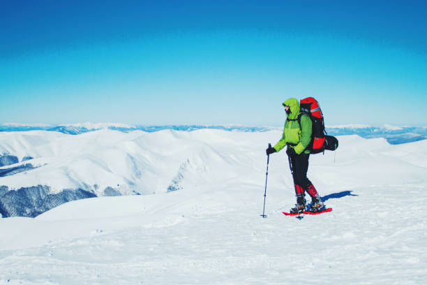 istock Winter hike in the mountains with a backpack and tent. 900860962