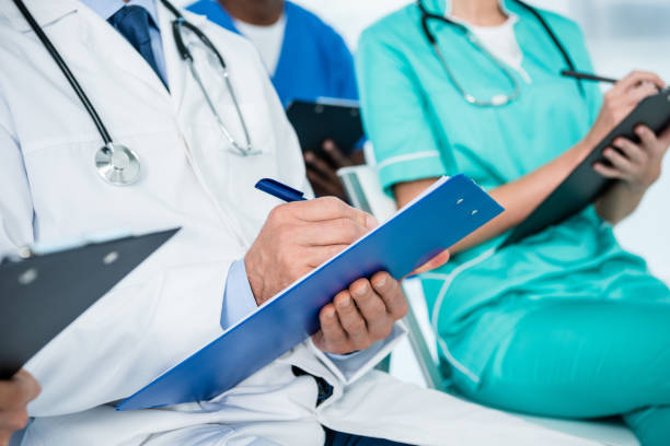 istock doctor writing in clipboard 900861478