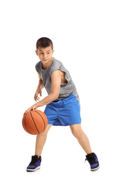 ragazzo che dribbling con un basket - basketball child dribbling basketball player foto e immagini stock