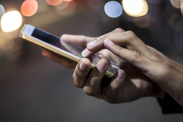 istock A hand holding a latest smart phone at night.a 900862538
