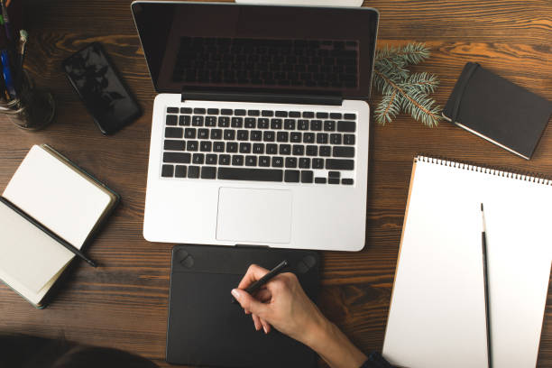 istock cropped shot of designer using graphics tablet and working with laptop at workplace 900862546