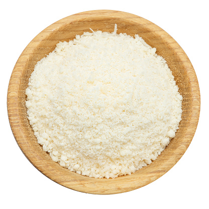 grated Parmesan cheese in wooden bowl isolated on white background