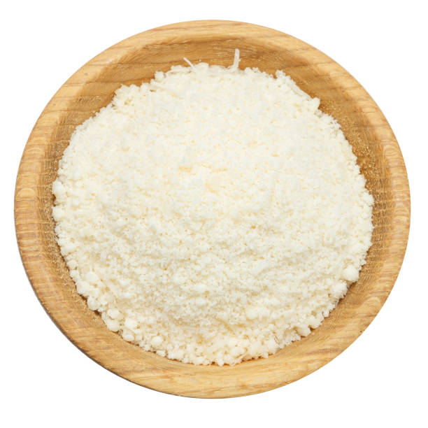 grated Parmesan cheese in wooden bowl on white background grated Parmesan cheese in wooden bowl isolated on white background parmesan cheese stock pictures, royalty-free photos & images